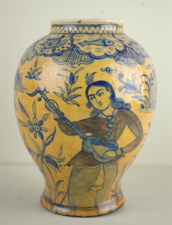 EARLY PERSIAN GLAZED CERAMIC VASE: possibly Safavid Iran, decorated with figures, animals, sea life and a bird, in blue, white and black tones, losses, hole to bottom, discoloration and crazing, 11in.