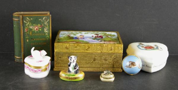7-PIECE TRINKET BOX GROUP: including a transfer-decorated dresser box depicting a courting couple, a metalware paint-decorated book-form box, a Wedgwood Beatrix Potter heart-shaped porcelain box, a Herend small heart-shaped por