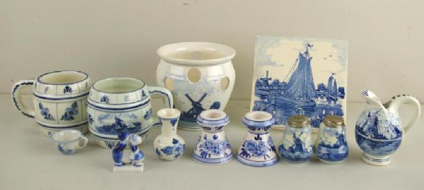 18-PIECE DELFT/HOLLAND BLUE AND WHITE GROUPING: includes planter, mugs, salt & pepper, cream pitcher, candleholders, tile, mini cup, tea cup/saucer, kissing couple figurine and small vase, tallest 5in.