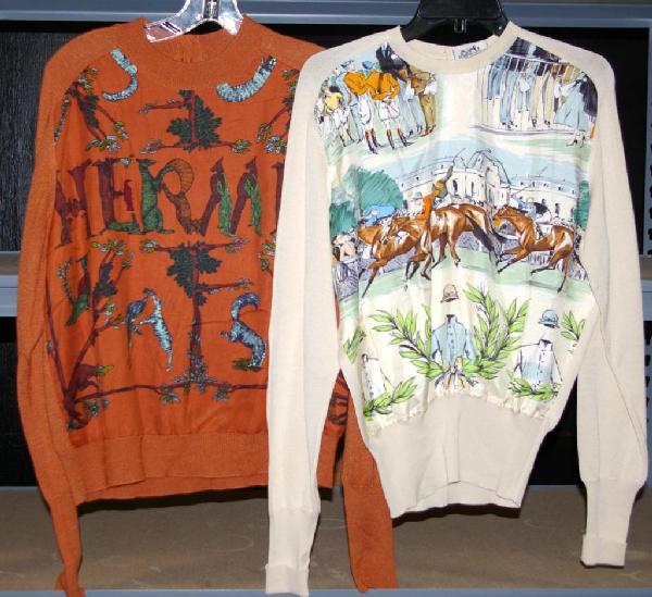 TWO HERMES SWEATERS: one rust tone depicting animals creating the "Hermes" name, Hermes Paris gold buttons on back, no interior label, the other in ivory tone depicting a polo scene, Hermes Paris gold buttons on back, int