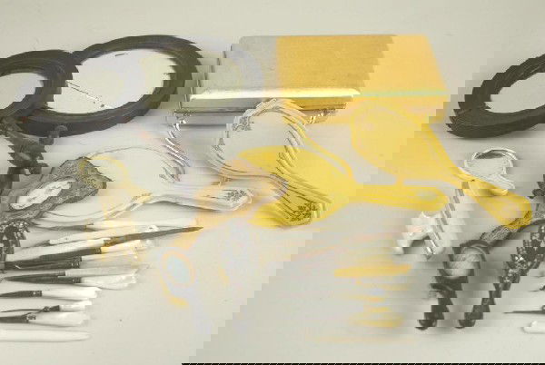 15+ PIECE VINTAGE VANITY GROUP includes a Volupte: 15+ PIECE VINTAGE VANITY GROUP includes a Volupte bag with stylized belt clasp, antique hand mirrors, brushes, mother-of-pearl manicure set, etc.