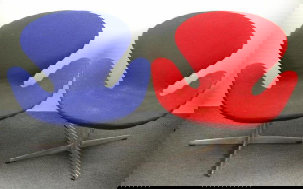 PAIR ARNE JACOBSEN/FRITZ HANSEN SWAN CHAIRS one bl: PAIR ARNE JACOBSEN/FRITZ HANSEN SWAN CHAIRS one blue and one red upholstered, on aluminum swivel bases, Fritz Hansen/Denmark label affixed to each, (foam petrification to both), 30x30x29in.