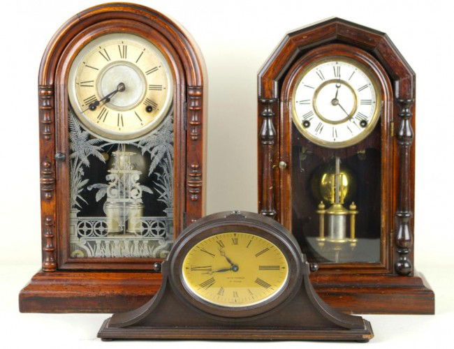 THREE MANTLE CLOCKS including walnut clocks by Ing: THREE MANTLE CLOCKS including walnut clocks by Ingraham and Ansonia with decorative side columns and faux mercury pendulums, each 16in., and a small tambour by Seth Thomas