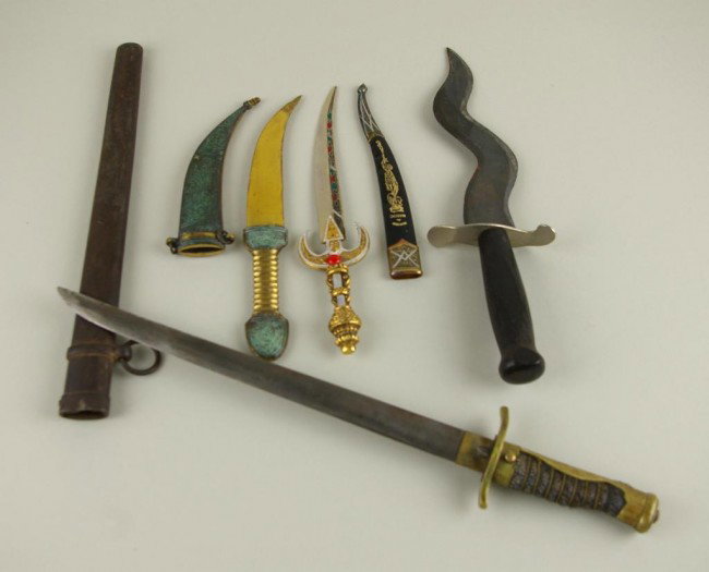 FOUR COLLECTIBLE DAGGERS including a Made in Israel: FOUR COLLECTIBLE DAGGERS including a Made in Israel example, souvenir du maroc example, wooden Japan example and one with beaded handle, longest 17in.