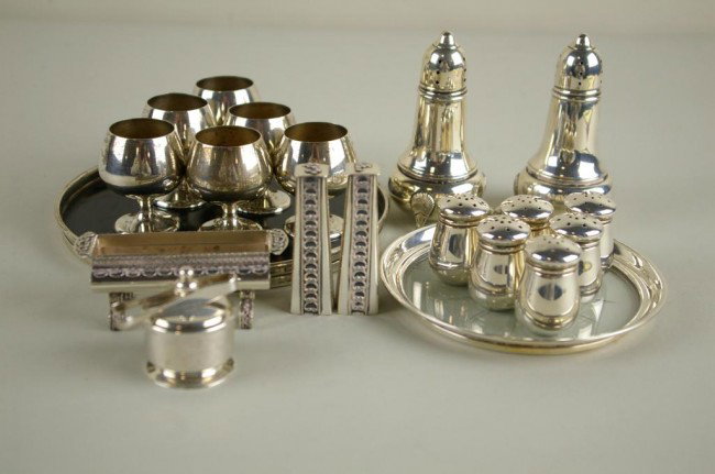 21-PIECE STERLING SILVER GROUP including a pair of: 21-PIECE STERLING SILVER GROUP including a pair of National footed salt and peppers, six Wolfenden salt and peppers, saccharin jar and tongs, a sterling-rimmed coaster, set of six Gorham cordials on m