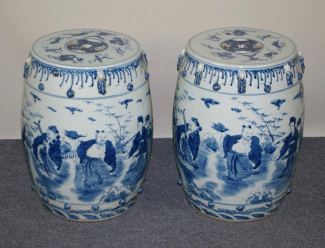 PAIR OF CHINESE BLUE & WHITE GARDEN SEATS: PAIR OF CHINESE BLUE & WHITE GARDEN SEATS depicting figures in a landscape, with raised figures and bosses (22" crack to one seat, minor losses to some of the raised figures, some pitting), 18in.