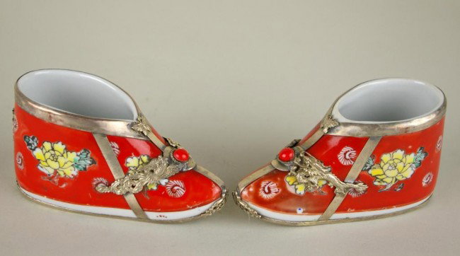 PAIR OF CHINESE METAL-MOUNTED PORCELAIN SHOES: PAIR OF CHINESE METAL-MOUNTED PORCELAIN SHOES in floral motif, silvertone mountings with applied dragon, bird and butterfly, cabochon stone embellishment, interior seal mark, punch mark at underside, 