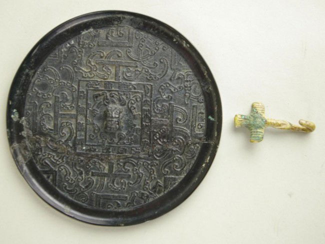 CHINESE BRONZE MIRROR AND BELT HOOK: CHINESE BRONZE MIRROR AND BELT HOOK mirror with “TLV” or “Square Rule” motif (repair), 4.5in., belt hook 2.5in. Provenance: Purchased Kenny & Higgins Asian Art, Washington, DC / each purported