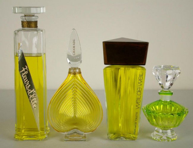 FOUR PERFUME DISPLAY BOTTLES: FOUR PERFUME DISPLAY BOTTLES including a 10" Nattie Rosenstein Fleurs d' Elle, a 7" Weil de Weil, an 8" Guerlain Chamade (no liquid), and a 5" unmarked green glass bottle (no liquid), not containing p