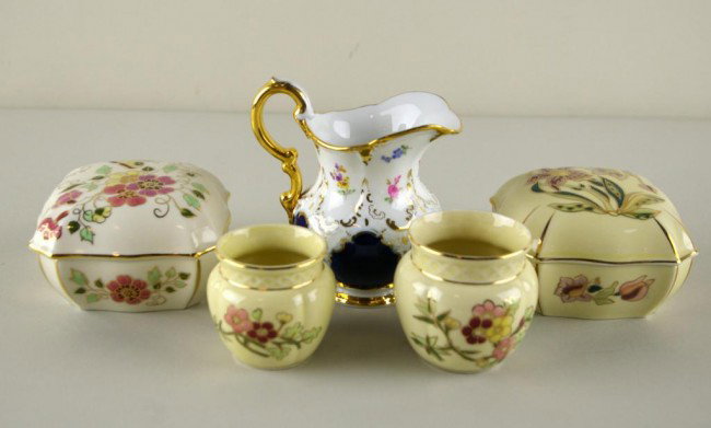 FOUR ZSOLNAY PORCELAINS & A MEISSEN CREAMER: FOUR ZSOLNAY PORCELAINS & A MEISSEN CREAMER Zsolnay includes two dresser boxes and two miniature vases, together with a Meissen gilt and floral decorated cream pitcher, tallest 5in.
