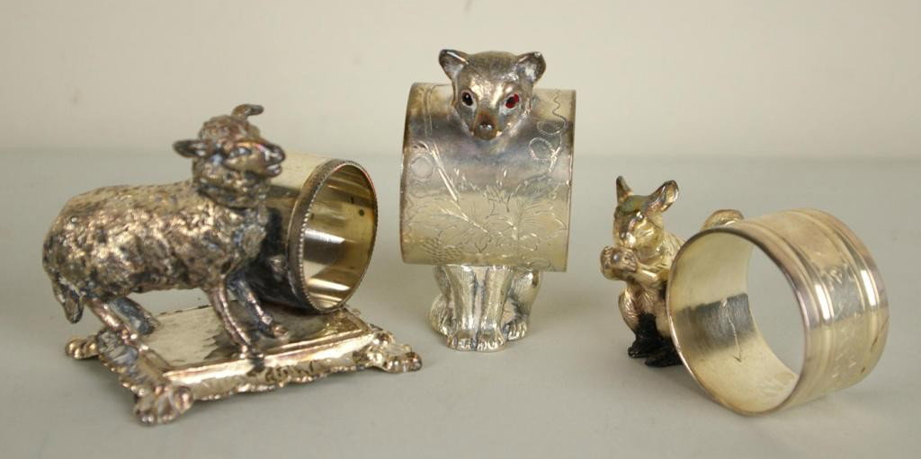 THREE FIGURAL SILVERPLATE NAPKIN RINGS: including a lamb #13 by Barbour, an unsgned fox with red glass eyes #4309, and an unsigned squirrel, tallest 3in.