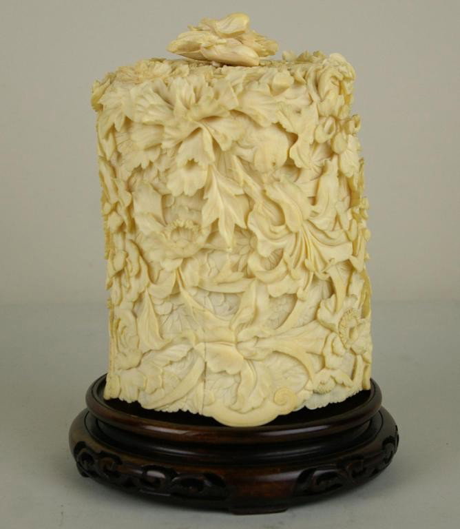 CARVED IVORY TUSK BOX: with allover floral decoration, removable cover, on round stand, losses and repairs, 7in. NO INTERNATIONAL SHIPPING.