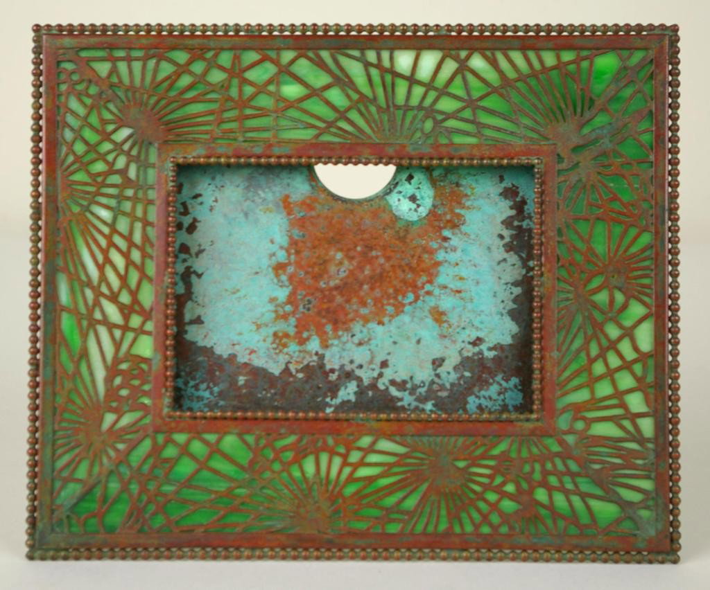 TIFFANY STUDIOS BRONZE PINE NEEDLE FRAME: green slag glass, easel back, stamped "Tiffany Studios, New York, 939", some oxidization, 7x8.5in.