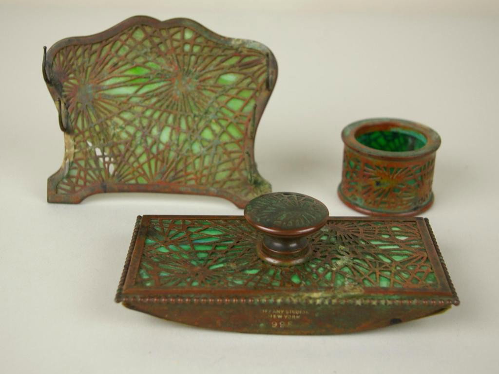 3-PIECE TIFFANY BRONZE PINE NEEDLE DESK SET: including a pen wipe, a rocker blotter, and an as-is pen rack (broken glass and missing one pen rack), green slag glass, stamped "Tiffany Studios, New York, 981 (wipe), 995 (blotter) and 1003 (pen rac
