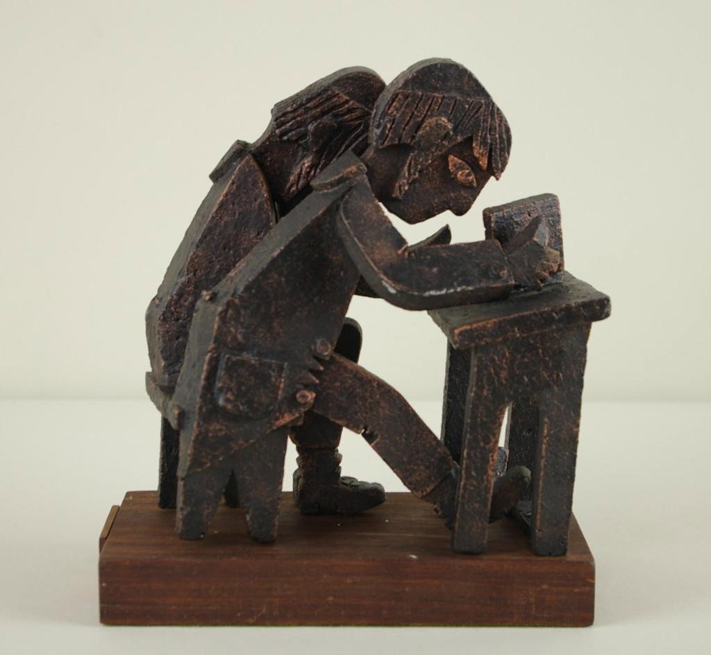 FRANK MEISLER (Israel, 1929-): metal sculpture on wood base of two Hasidic students studying and praying at a desk, pen signed on affixed wood plaque "Frank Meisler, Old Jaffa, Israel, 1975, 76/250", 8x8x4in.