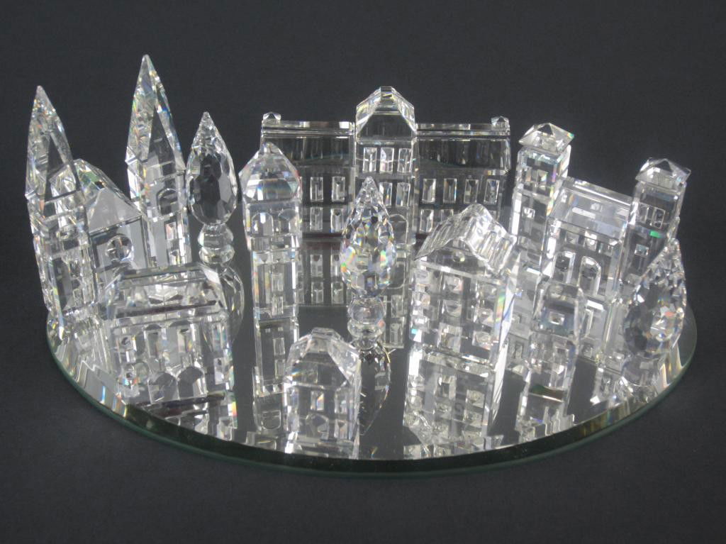 11 SWAROVSKI SILVER CITY FIGURES: including a cathedral signed "G. Stamey 6.11.94", a tower, gates, two (2-piece) house sets, town hall, and a 3-piece poplar set, mirrored glass base, with boxes, tallest 2in.