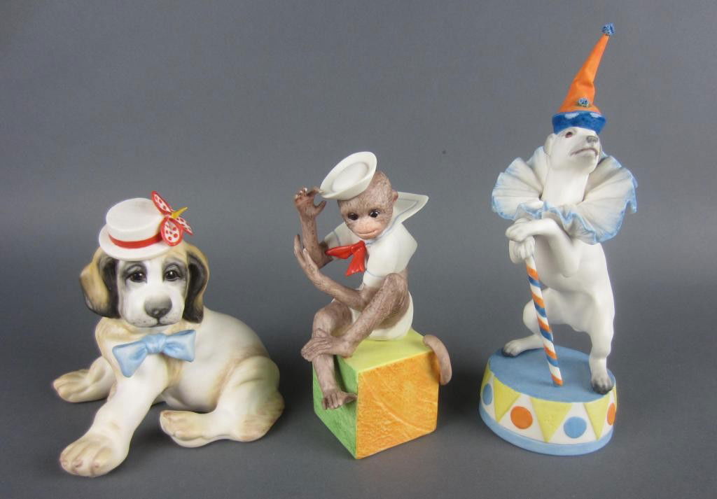 THREE CYBIS PORCELAIN CIRCUS THEMED FIGURES: including a monkey, a perched clown dog, and a seated dog in hat, tallest 8in.