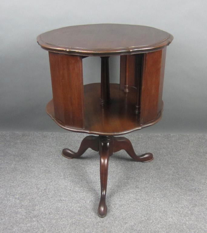 MAHOGANY REVOLVING BOOK TABLE: single tier, pad feet 26x20in.