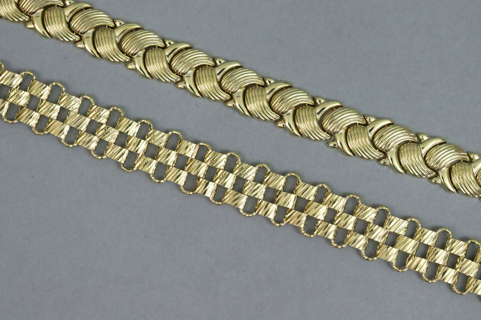 (2) 14K FANCY LINK BRACELETS: (2) 14K FANCY LINK BRACELETS each stamped 'AK 14K Turkey', tallest 15mm, one with safety catch, each approx. 8in., hollow gold, gross weight 31.8gms., part of an estate collection mainly acquired thro
