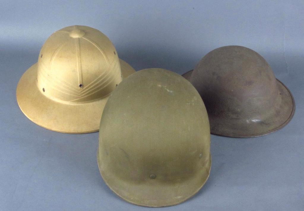 THREE US HELMETS: including a Marine Corps WWII Pith helmet with brown leather sweatband #W2177, a WWI doughboy helmet (no chin strap, some liner remaining), and a WWII M-1 helmet liner with intact webbing The Marino C
