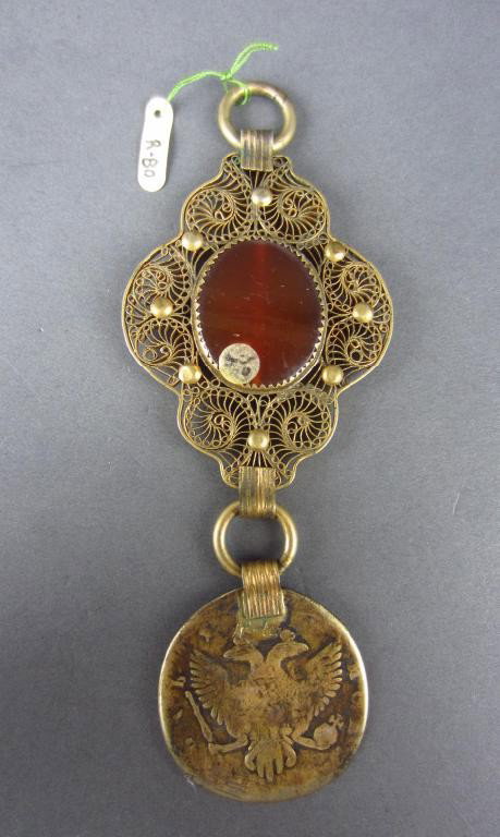 CARNELIAN FILIGREE PENDANT WITH ELIZABETH I RUBLE: carnelian done in gilt filigree, suspended below is an old Russian ruble coin also gilded of Elizabeth I, worn face, attached is government inventory list #35 article 3908, from collection of Grand Du