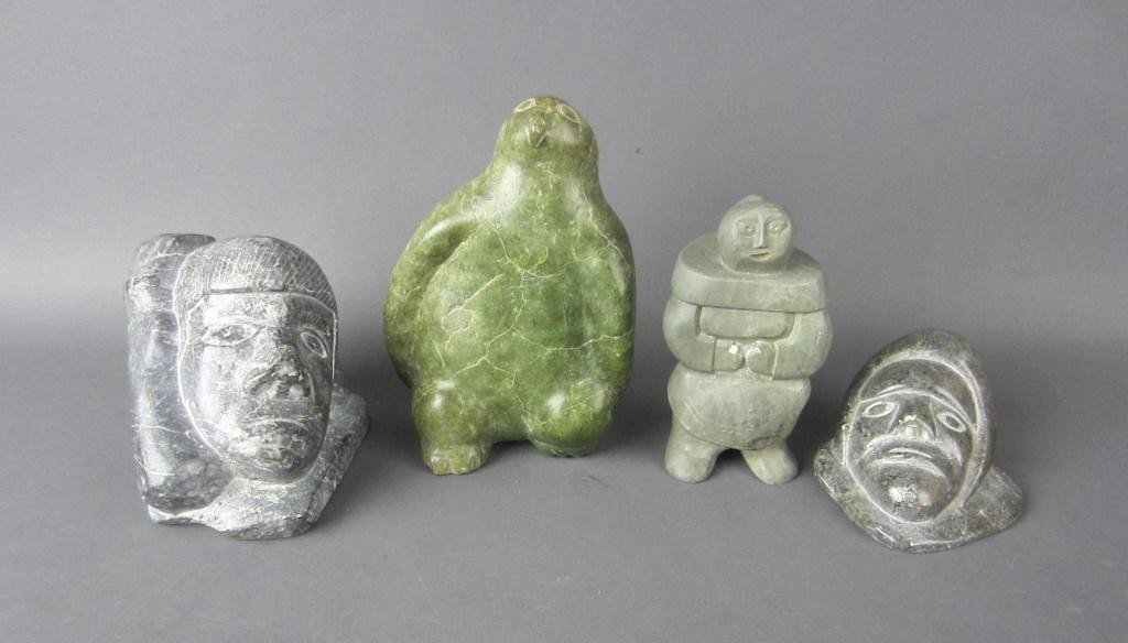 FOUR INUIT CARVED SOAPSTONE FIGURES: including a standing penguin, a standing mother & child signed illegibly (something missing from hand), a mask with hand and foot, and a mask with Canadian Eskimo Art label signed Semeonie and numbere