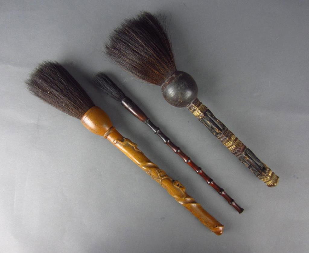 THREE CHINESE CALIGRAPHY BRUSHES: including one with climbing monkeys, one with caged balls, and one in bamboo style, longest 17in.