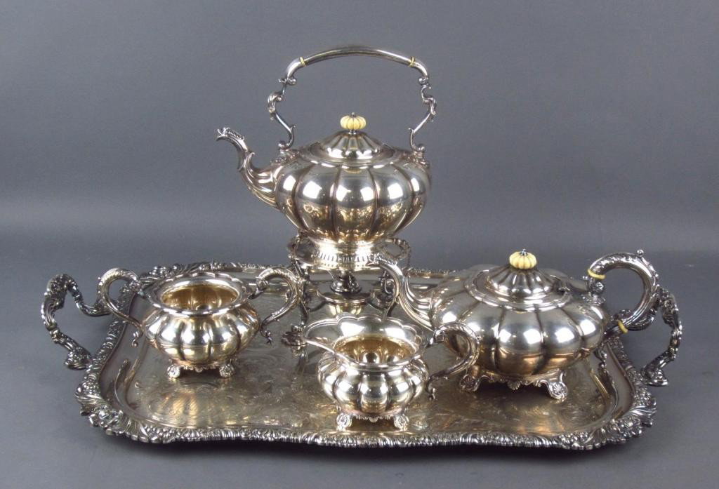 FIVE-PIECE ENGLISH SILVERPLATE TEA SERVICE: with ivory finials, melon-form service pieces include a tilting hot water kettle, tea pot, creamer and sugar, on a matching rectangular tray, standing lion inside circle mark, stamped Made in England,