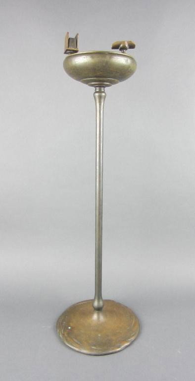 TIFFANY STUDIOS BRONZE SMOKING STAND: having a circular bowl inset with two rests and a match holder, underside of base signed Tiffany Studios New York 1649, 28in.