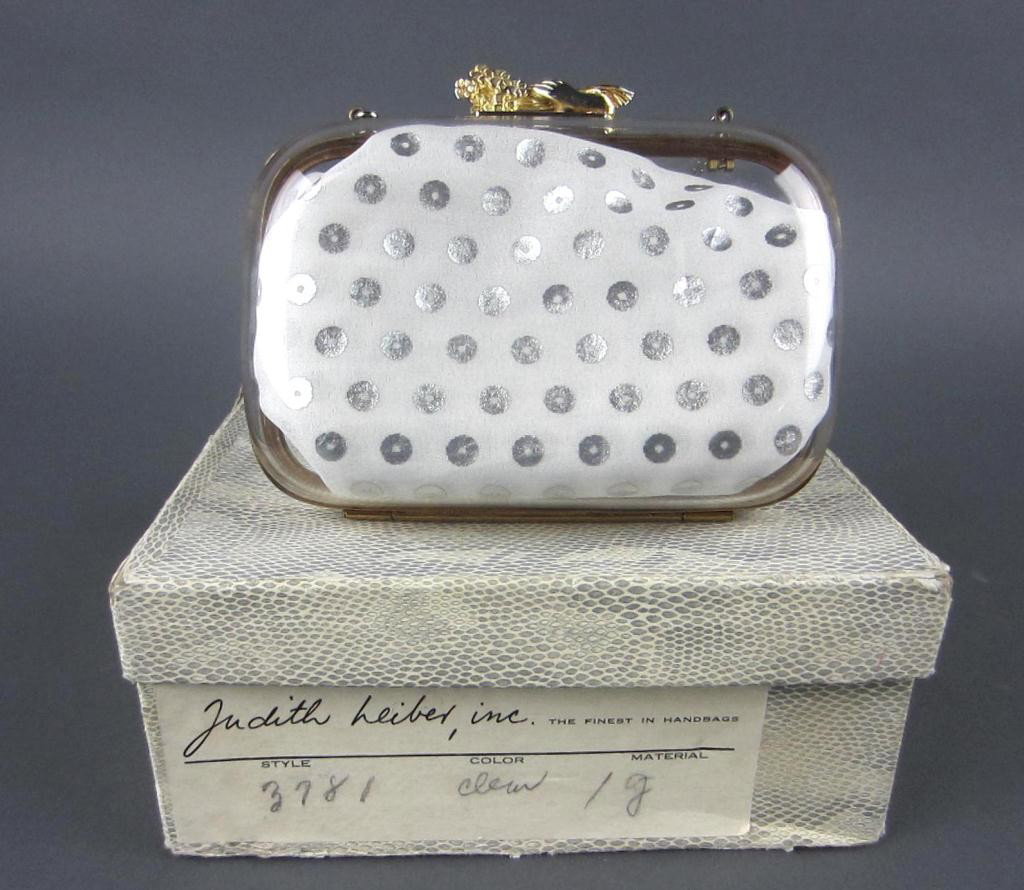 JUDITH LEIBER LUCITE BAG WITH HAND-FORM CLASP: the clasp in the form of a hand holding a bouquet of flowers, goldtone trim and chain strap, Judith Leiber metal tag, 5x6in.