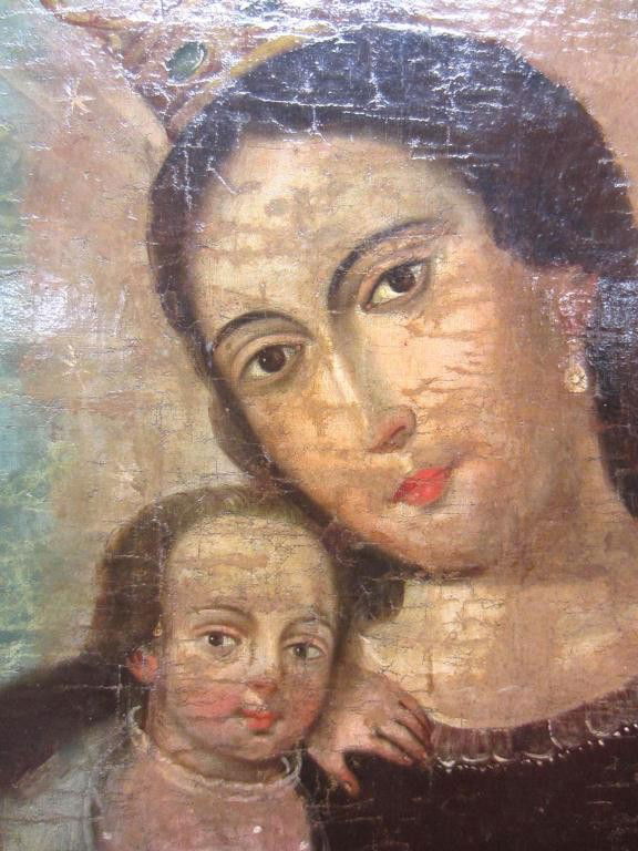 SPANISH COLONIAL RETABLO OF THE MADONNA AND CHILD: oil on canvas laid down on board, heavily restored and varnished, 18th/19th century, contemporary frame, 15x11in.