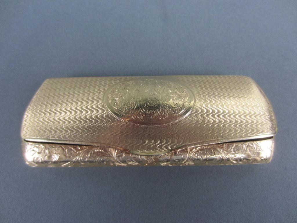 14K GOLD EYEGLASS CASE, BATTIN & CO.: base etch-decorated in allover floral and scroll design, hinged cover with center cartouche, marked 14K with B over trident mark, green velvet lining, 61.4gms.