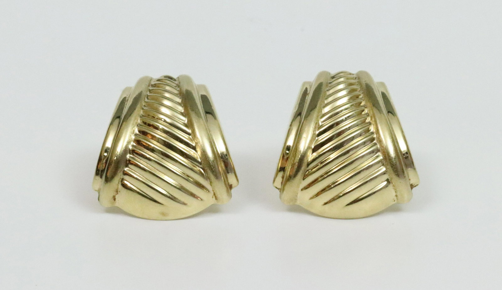 PAIR 14K HOLLW GOLD OMEGA CLIP EARRINGS: in ribbed design, stamped 14K (one omega clip sits slightly off center), with presentation box, 1.1x1in., 7.6gms., Opening Bid $200