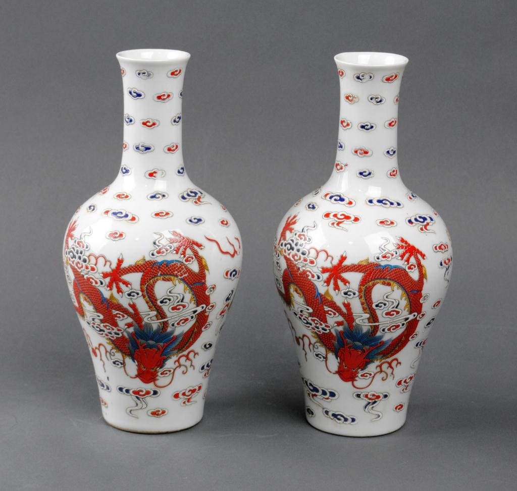 PAIR OF CHINESE PORCELAIN DRAGON VASES: each painted with a red and a green dragon amongst allover clouds, spurious Chien Lung seal mark, 9in.