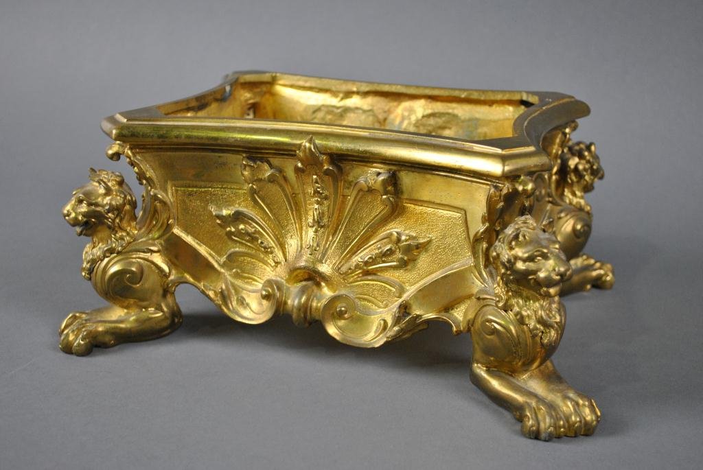 FRENCH EMPIRE-STYLE DORE BRONZE PLANTER OR BASE: with serpentine panels decorated in palmette, shell and scroll motif, raised on lion-sphinx feet, 19thC., 5x11x9in.