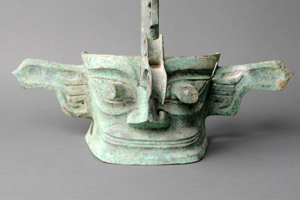 CHINESE ARCHAISTIC BRONZE MASK: reminiscent of the ruins of the Bronze Age in the Shang Dynasty from southwest China's Sichuan Basin, two-piece, with vertical eyes, 14x16in.