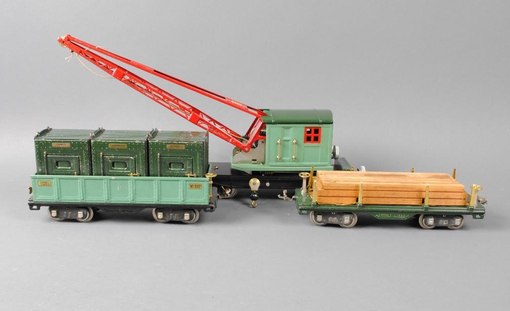 THREE LIONEL PRE-WAR STANDARD GAUGE CARS: including a #512 gondola car, a #511 lumber car, and a #219 crane car, together with three #205 freight containers, see photos for condition