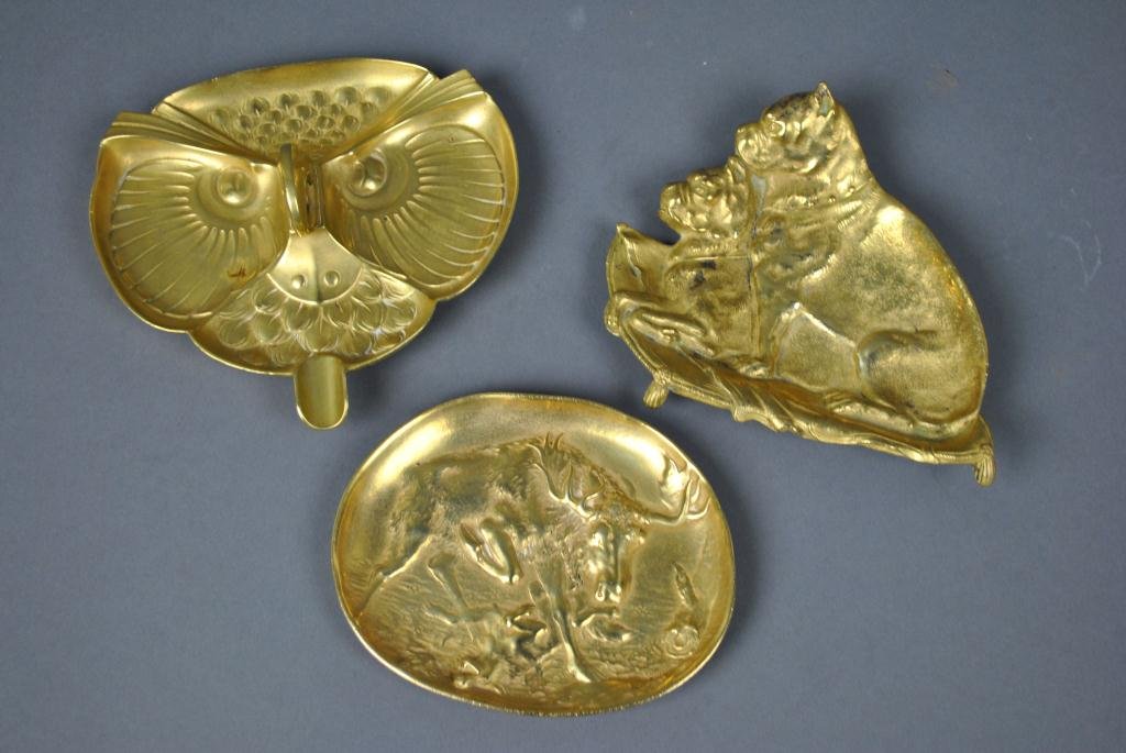THREE BRASS ANIMAL DISHES: including a dish with two dogs, a Berndorf hunt scene, and an owl-form cigar cutter/ashtray, widest 6in.