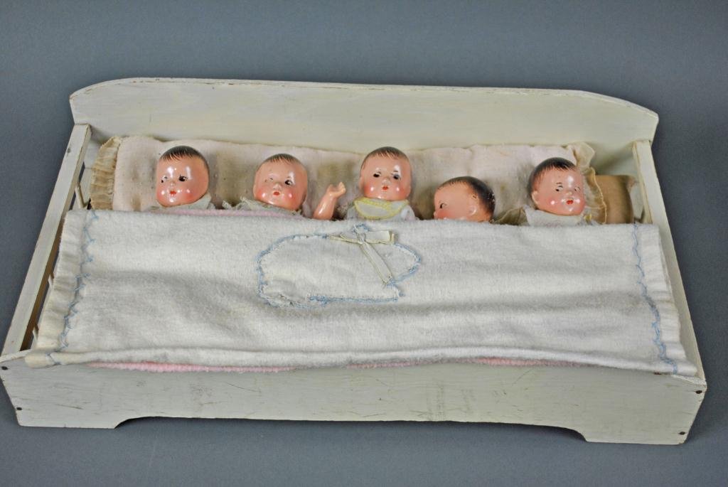 SET OF MADAME ALEXANDER DIONNE QUINTUPLET DOLLS: in composition, in their original wooden bed w/long pillow, mattress & covers, clothed in blue polka dot dresses with lace trim, each having their original pinned flannel diaper and name bibs, jointed