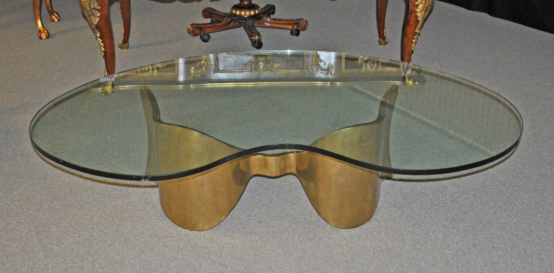 SILAS SEANDEL COCKTAIL TABLE: with kidney-shaped glass top on free-form brass base, 18x66x42in.