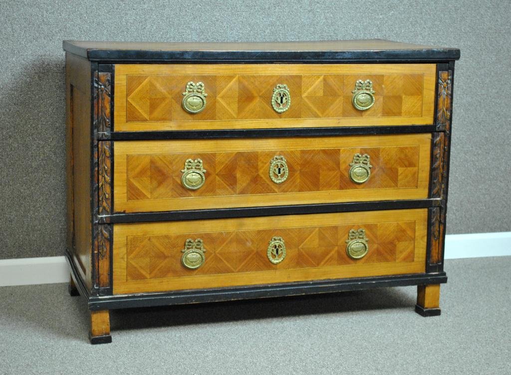ANTIQUE CONTINENTAL CHEST IN THE BIEDERMEIER TASTE: the rectangular dovetailed top above three parquetry paneled drawers with urn and ribbon cast brasses, ribbon carved stiles, ebonized trim, on block feet, 18th century, 30x40x20in.