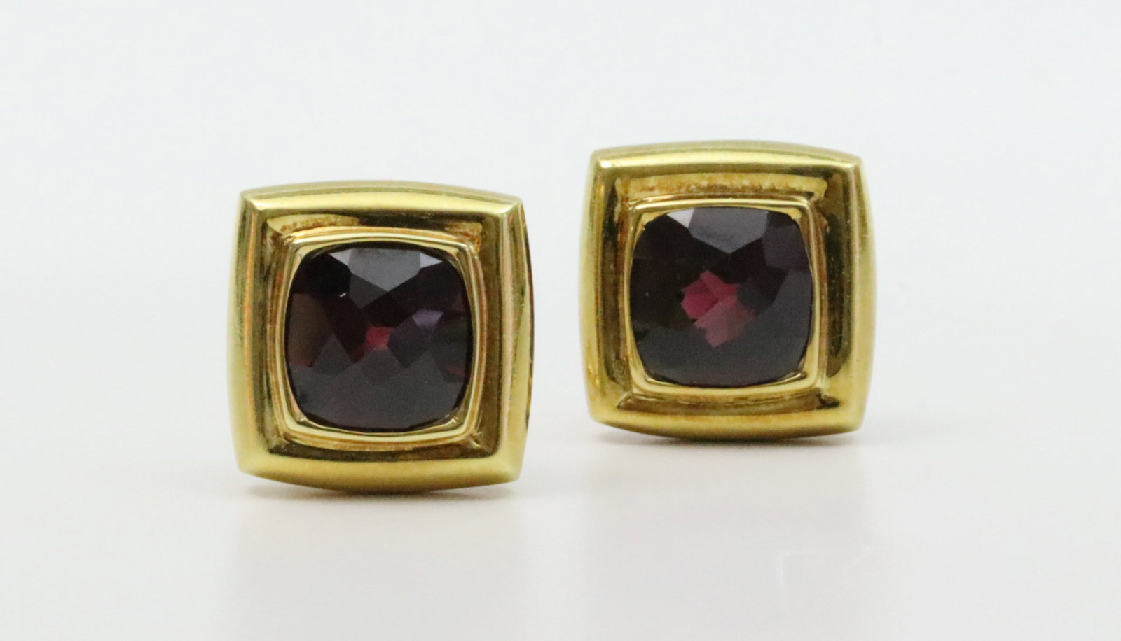 PAIR 18K RHODOLITE GARNET EARCLIPS: each set with a cushion rose cut garnet approx. 9x9mm, overall 16x16mm, in yellow gold, stamped 750, and with unidentified hallmark, omega backs, 19.8gms.