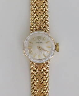 LADIES 14K ROLEX COCKTAIL WATCH: 15mm round case, silvered dial with gold baton markers and hands, dial marked 'Rolex Swiss', case interior stamped 'Rolex 86493' with logo, case back stamped 14K with monogram, mechanical movement sta