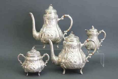 (4) PC STERLING GERMAN HANAU COFFEE & TEA SERVICE: in Rococo style, includes a coffee pot, tea pot, covered sugar and covered creamer, all with scroll and floral relief decoration, each marked 'Sterling 925 Hanau-R Germany R.O.', and with maker's