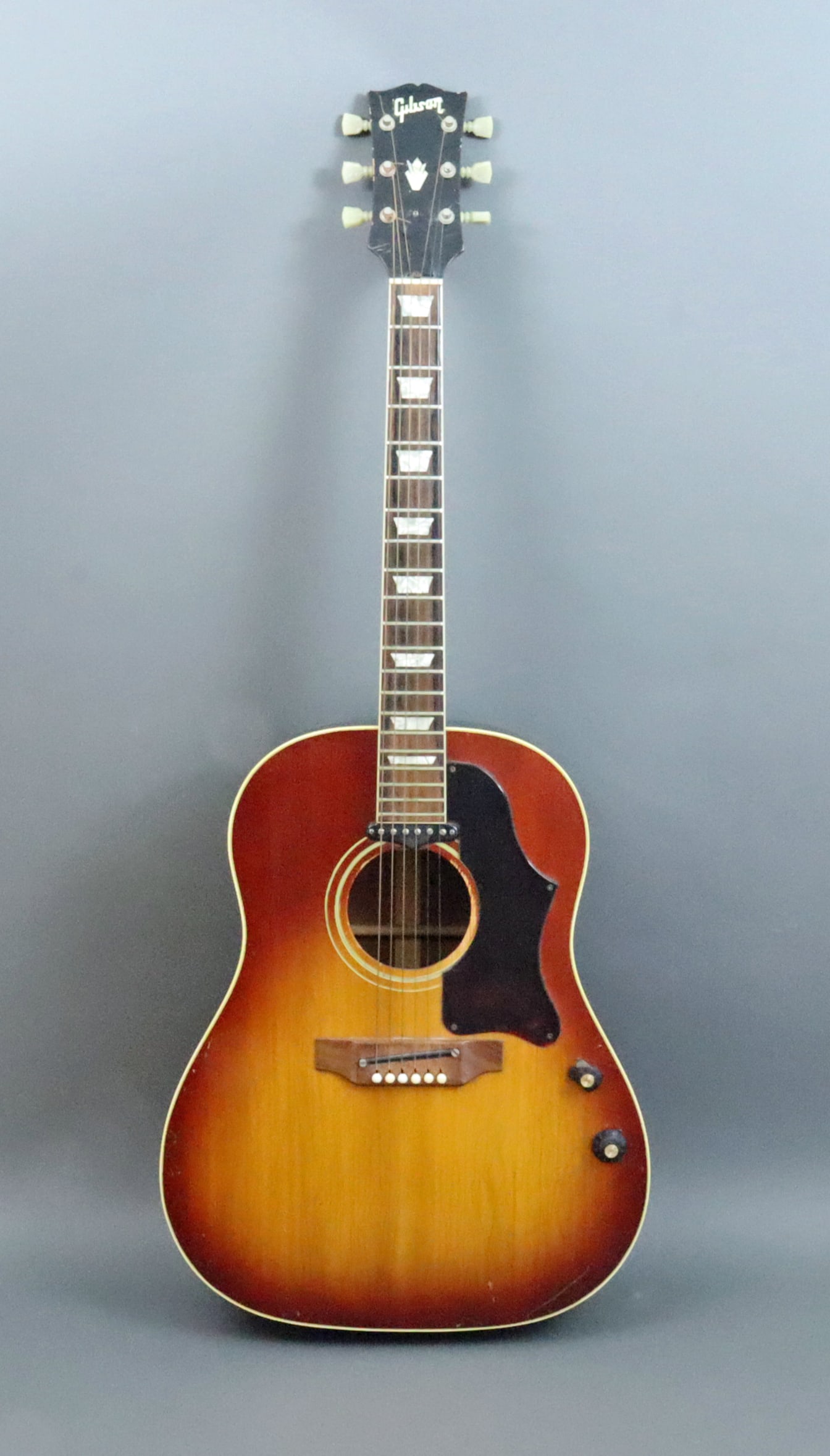 1960'S GIBSON J-160E SUNBURST ACOUSTIC GUITAR: acoustic and electric, serial #840462, worn, nicked and with weather checking, cracked pick holder, and with chipped/broken volume knob, however overall in better condition than described (see images)