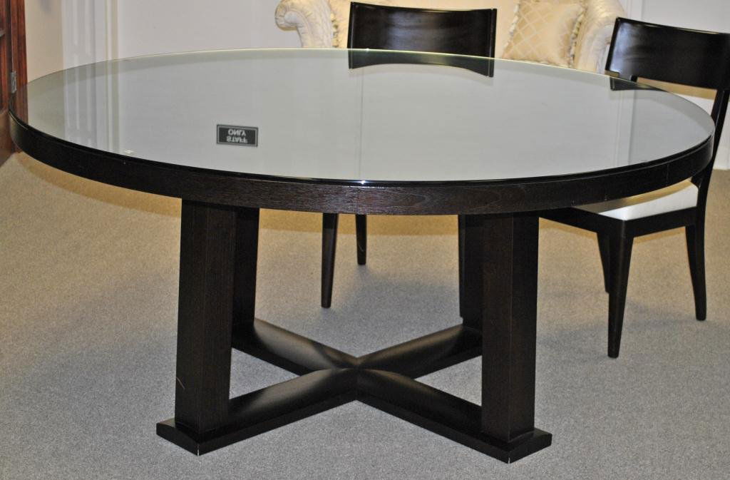 CHRISTIAN LIAIGRE - ROUND DINING TABLE: Holly Hunt Collection, in walnut with espresso finish, custom beveled glass top, 30x67in. Condition: Minor veneer loss approx. 1" to the underside, scattered dings and scratches commensurate with age