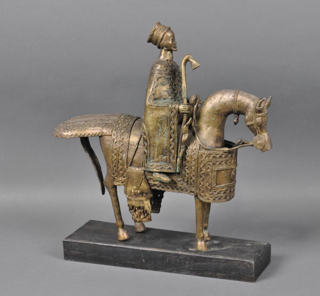 AFRICAN BRONZE EQUESTRIAN GROUP - BOBO TRIBE: probably Burkina Faso, comprising a separately cast horse and rider, on wood base, overall 15x14in.