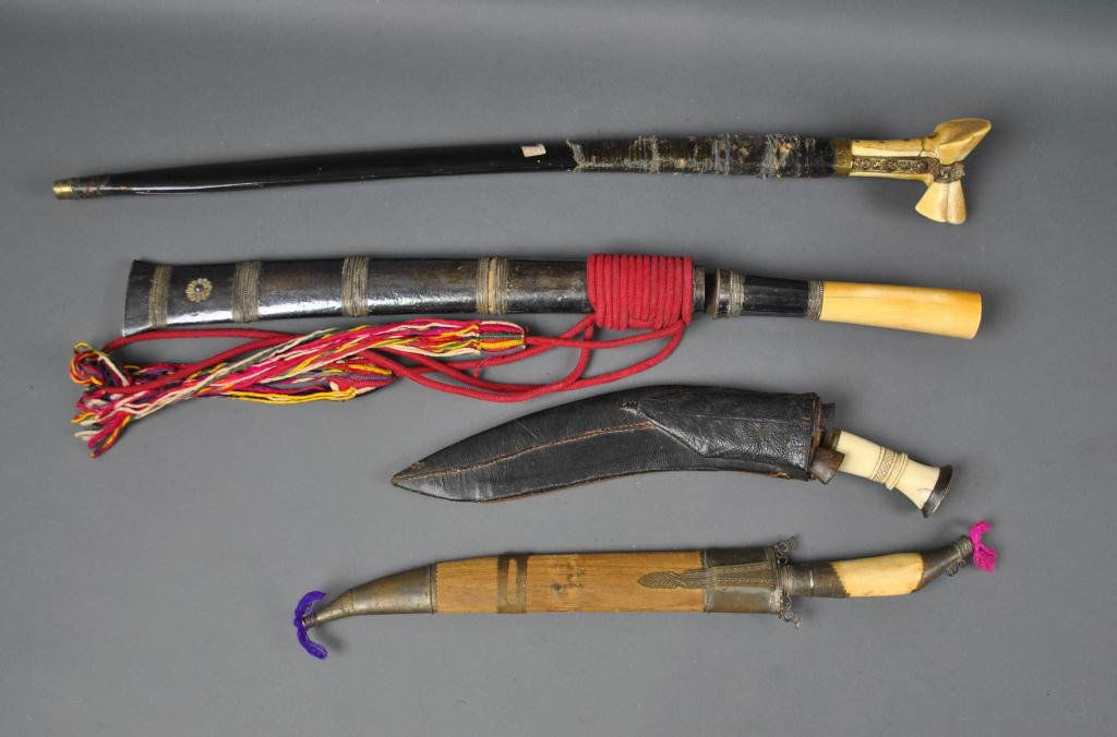 FOUR BONE-HANDLED METAL EDGED ETHNOGRAPHIC WEAPONS: including a Gurkha-type knife with accompanying small knives, and a Saudi-type sword with Arabic lettering, some rust and pitting, longest 32in.