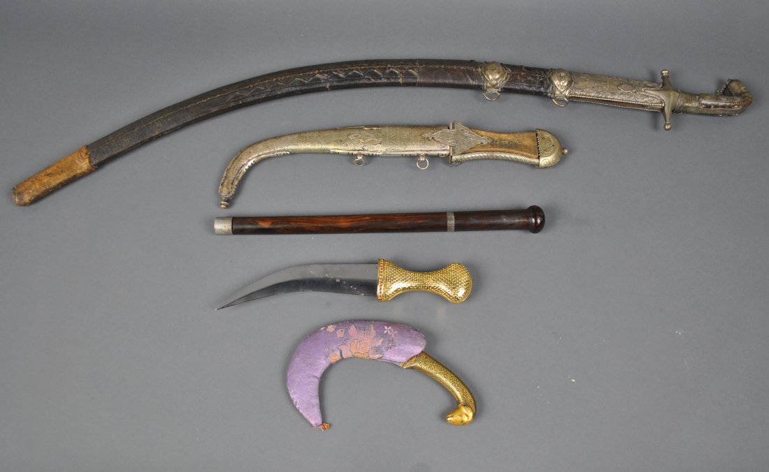 FIVE METAL EDGED ETHNOGRAPHIC WEAPONS: including a long sword, likely Saudi, a baton with pull-out blade, curved blade short sword with metal scabbard, and two curved blade knives, one with lamb handle, longest 38in.