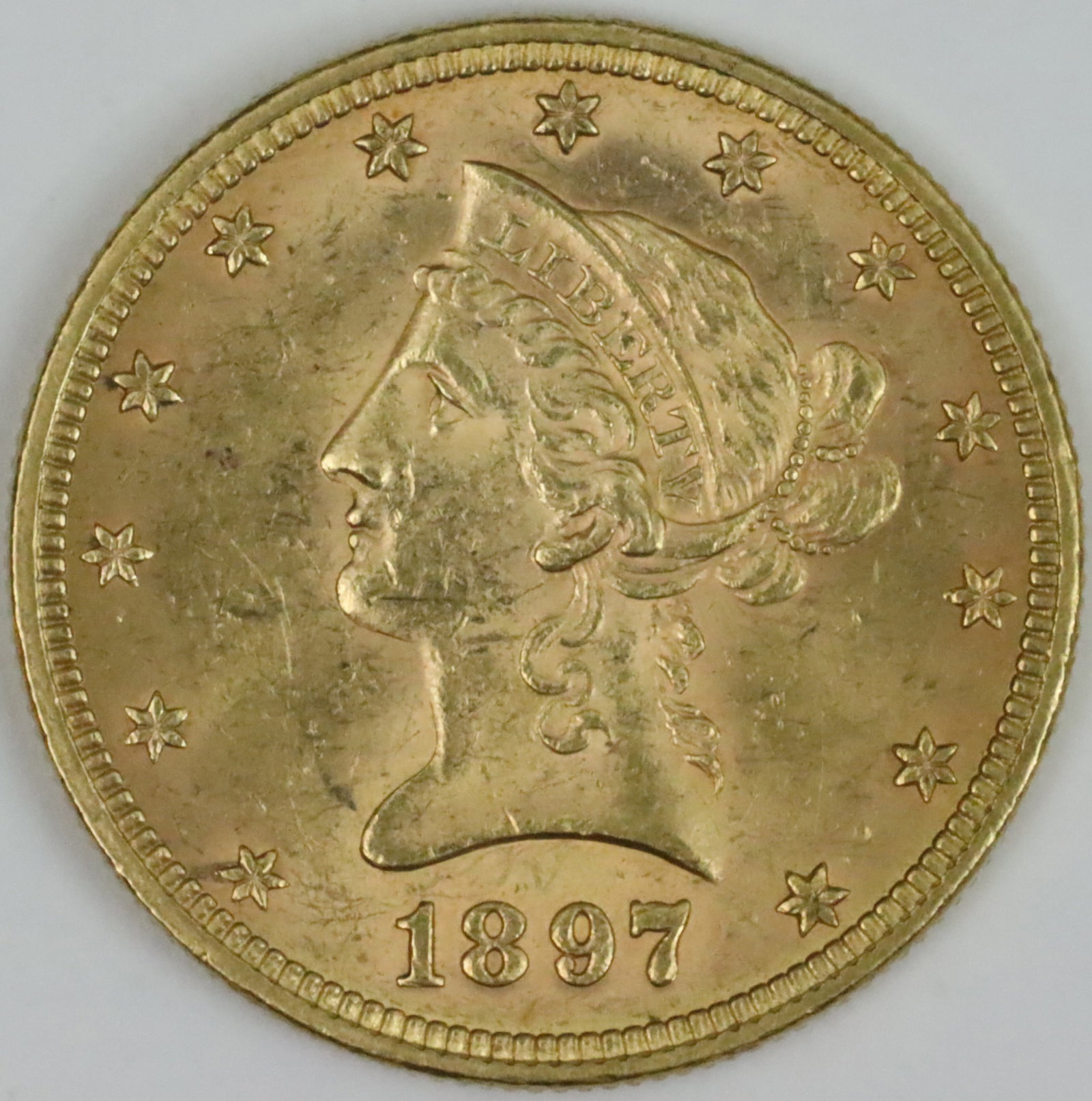 1897 $10 LIBERTY HEAD GOLD COIN: coin is 0.900 purity, 16.71gms., ungraded, likely AU53+, (see images), Opening Bid $600